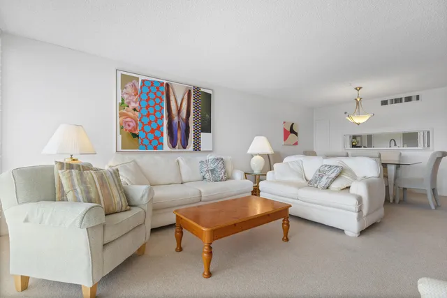 a living room with furniture and a book shelf