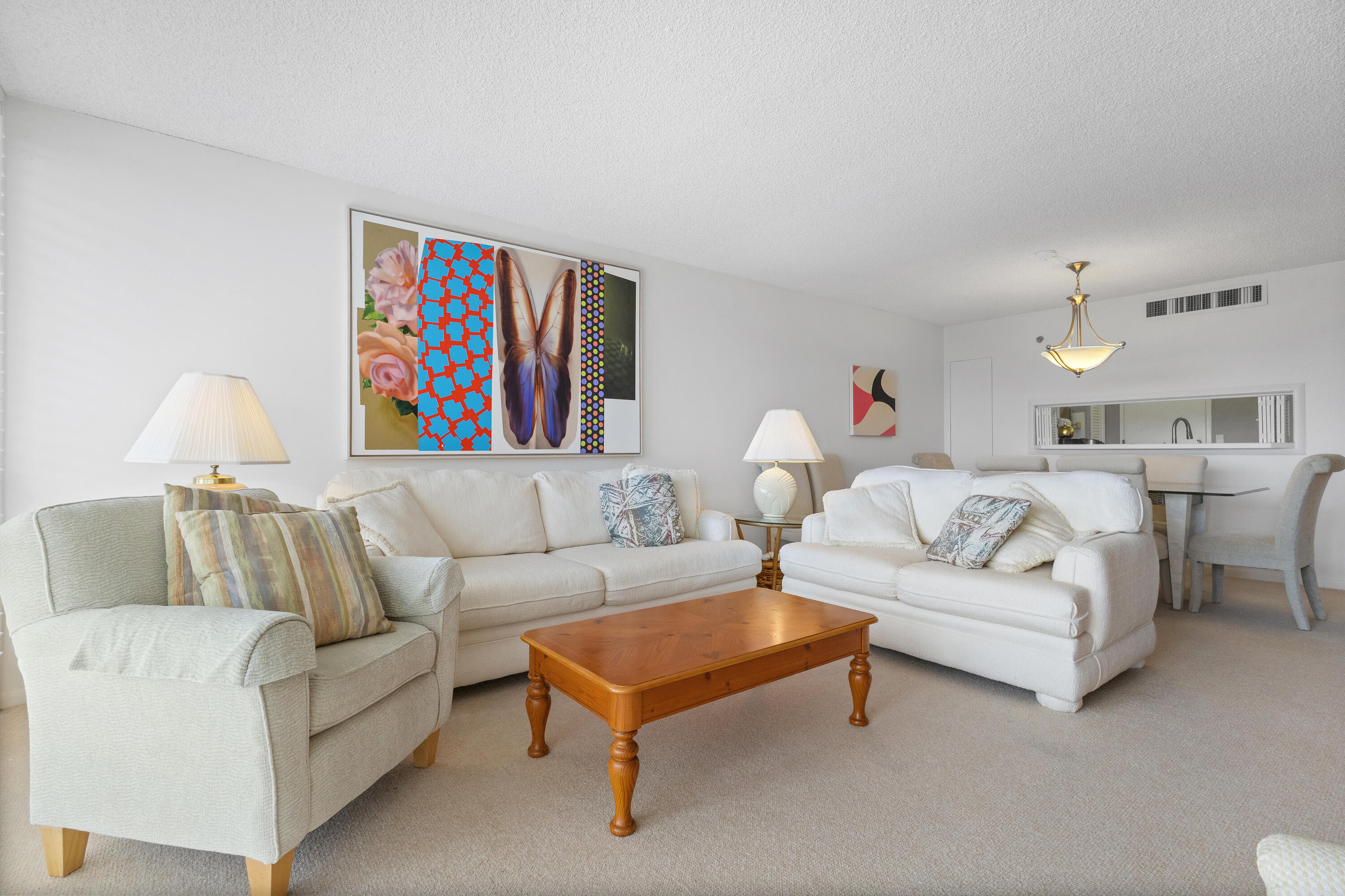 4750 South Ocean Boulevard, Unit 409 Highland Beach, FL 33487 - Photo 7 of 26 a living room with furniture and a book shelf