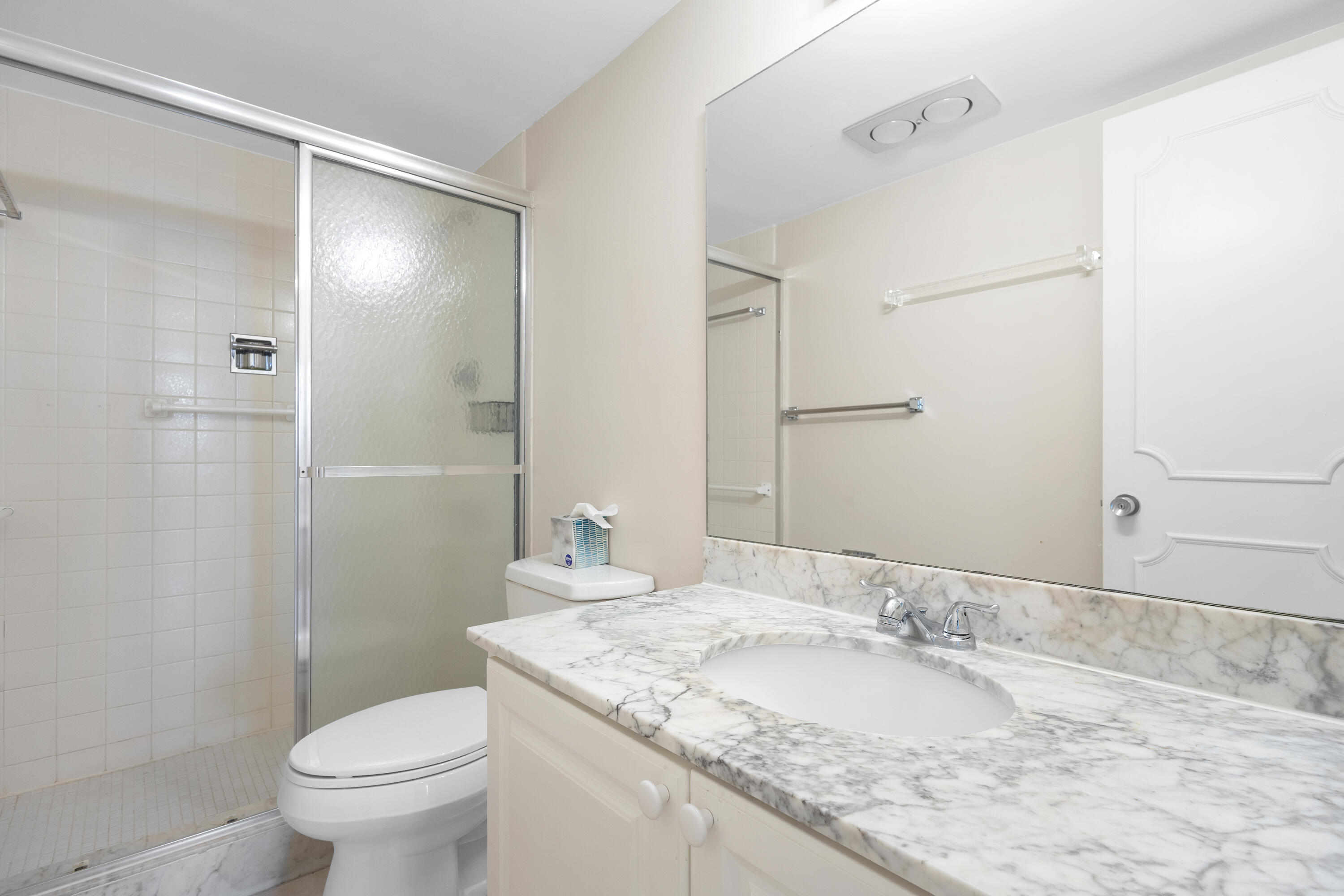 4750 South Ocean Boulevard, Unit 409 Highland Beach, FL 33487 - Photo 9 of 26 a bathroom with a granite countertop sink toilet and shower