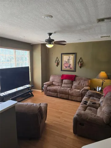 a bedroom with furniture and a flat screen tv