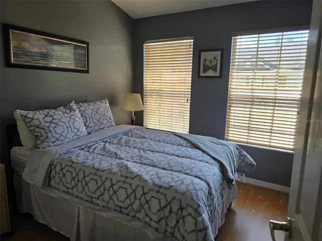 a bed sitting in a bedroom next to a window