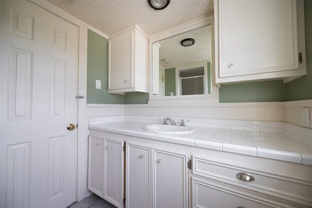 a bathroom with a sink and a mirror