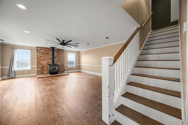 a view of empty room with wooden floor and windows