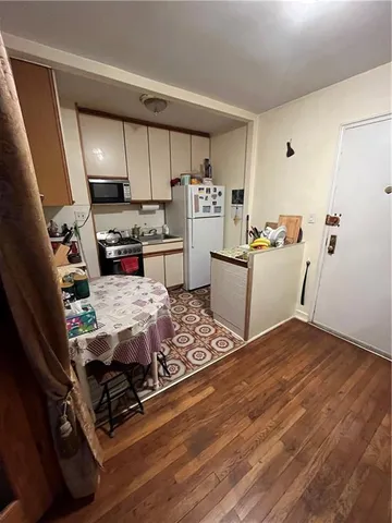 a kitchen with stainless steel appliances a stove a refrigerator and cabinets
