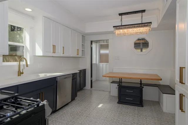 a room with wooden cabinets and stainless steel appliances