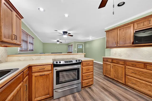 a kitchen with stainless steel appliances granite countertop a sink and cabinets