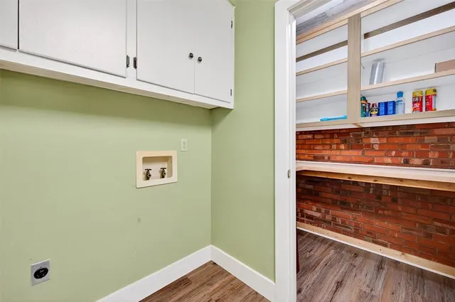 a view of a kitchen with fridge and wooden floor