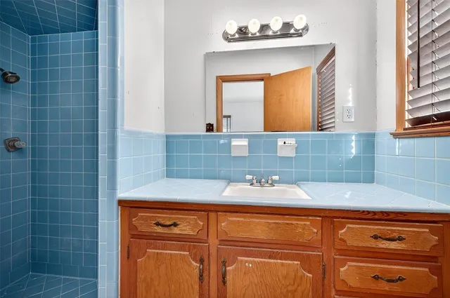 a bathroom with a sink and a mirror