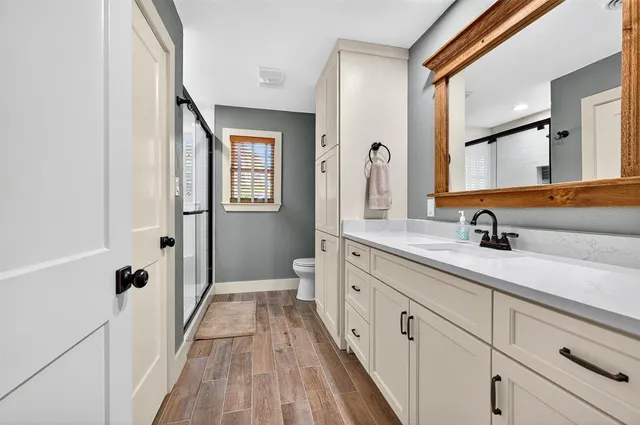 a spacious bathroom with a double vanity sink and mirror