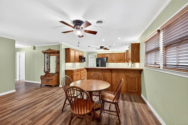 a view of a dining room with furniture and wooden floor
