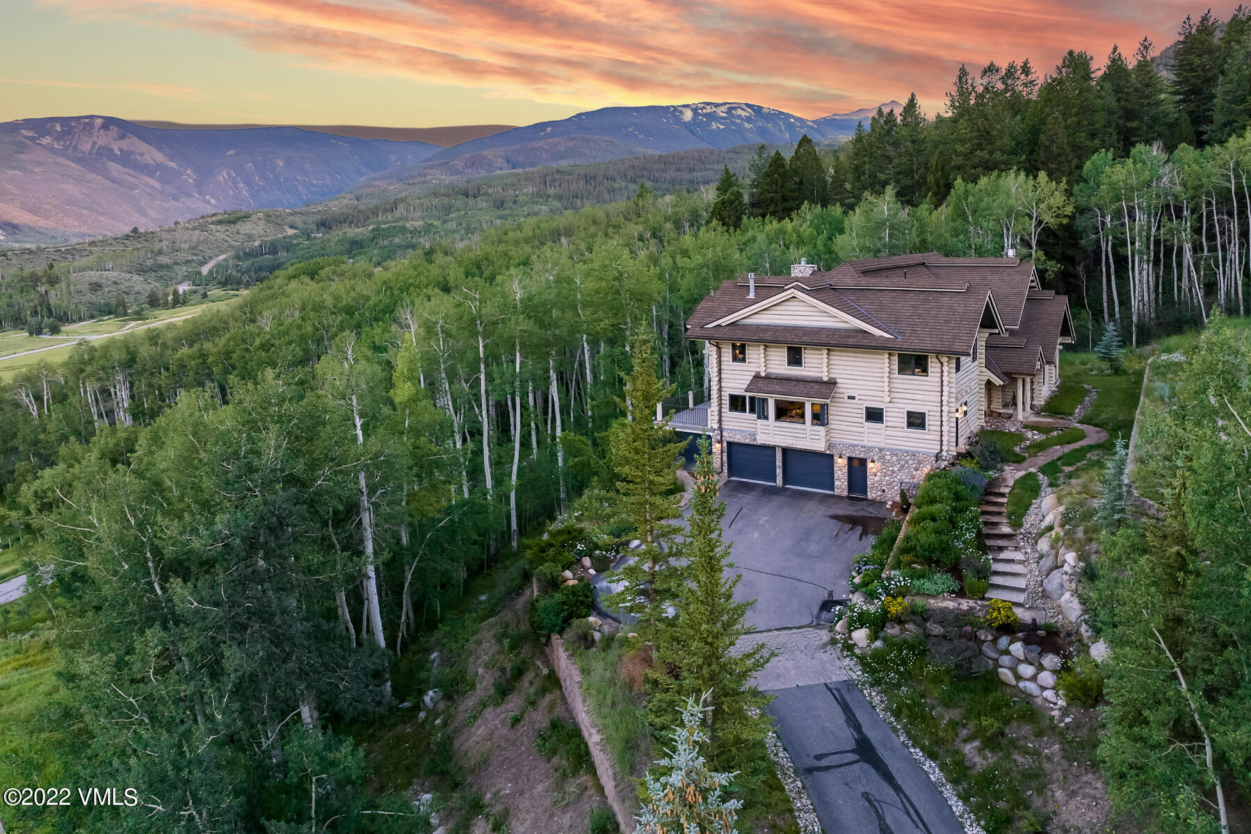 a view of a house with a yard and a wooden fence