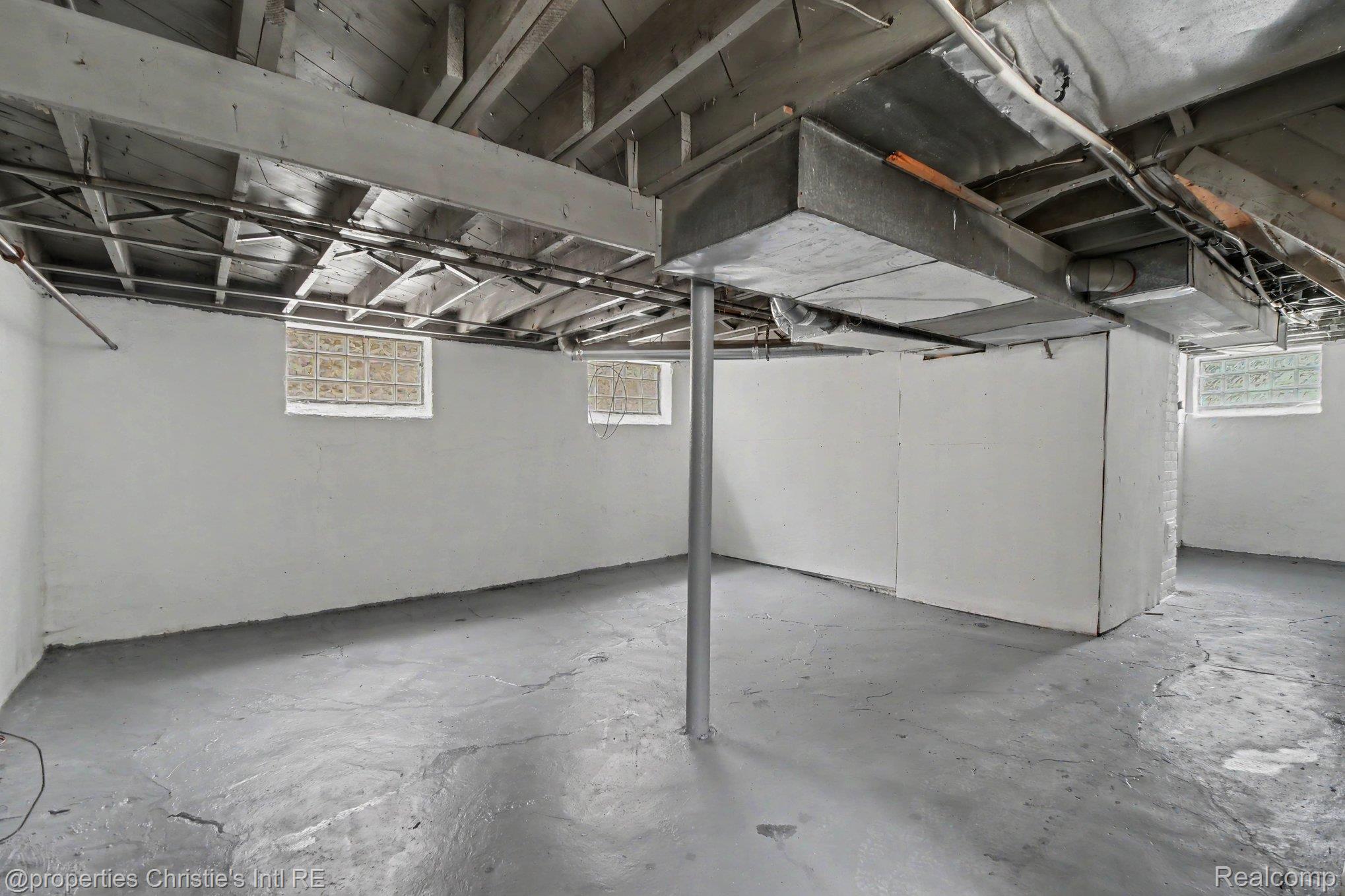 5911 Yorkshire Road Detroit, MI 48224 - Photo 12 of 14 Spacious unfinished basement featuring concrete flooring and exposed ceiling beams