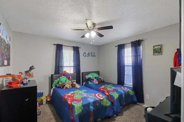 a bedroom with bed and windows