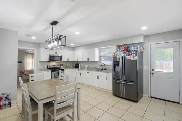 a kitchen with stainless steel appliances a refrigerator sink and microwave