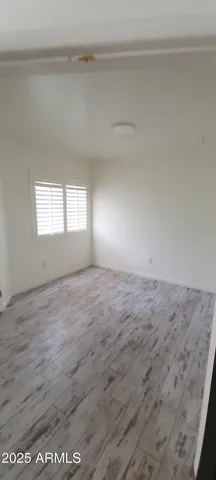 a view of wooden floor and windows in a room