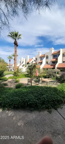 a living room with furniture a ceiling fan and a flat screen tv