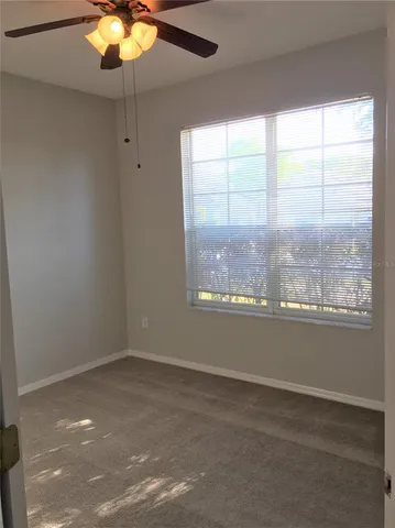 an empty room with a ceiling fan
