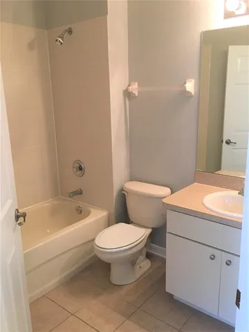 a bathroom with a toilet a sink and a mirror
