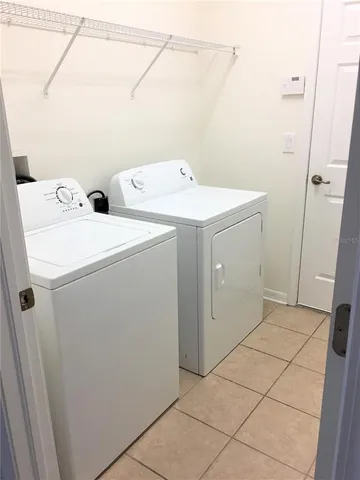 an empty room with a chandelier fan