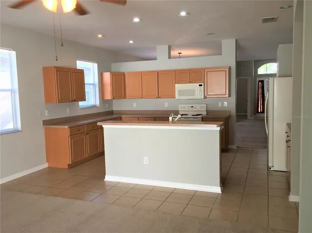 a bathroom with a sink a toilet and a shower