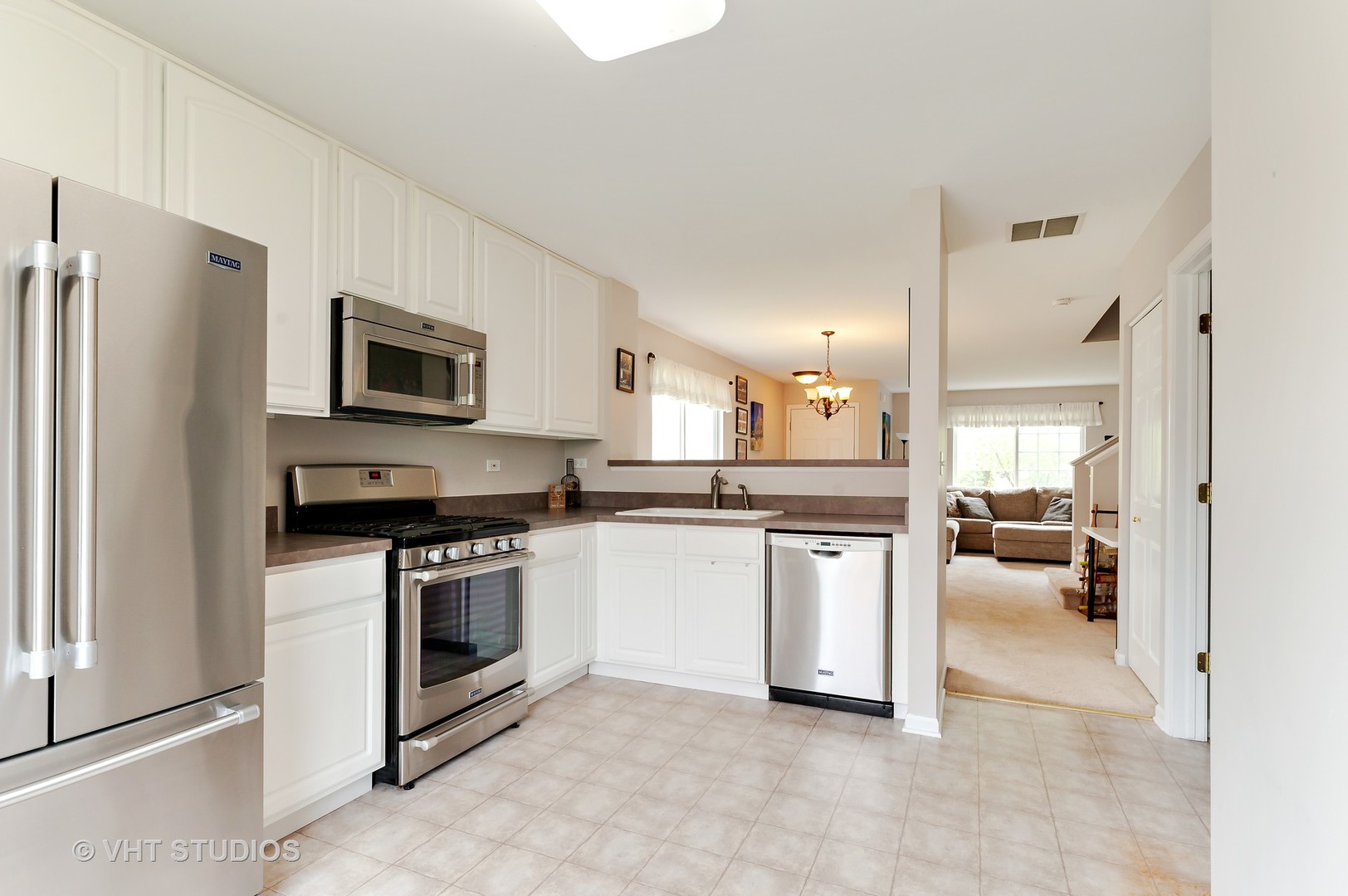86 Amberly Drive Round Lake, IL 60073 - Photo 5 of 12 a kitchen with a refrigerator stove top oven and sink