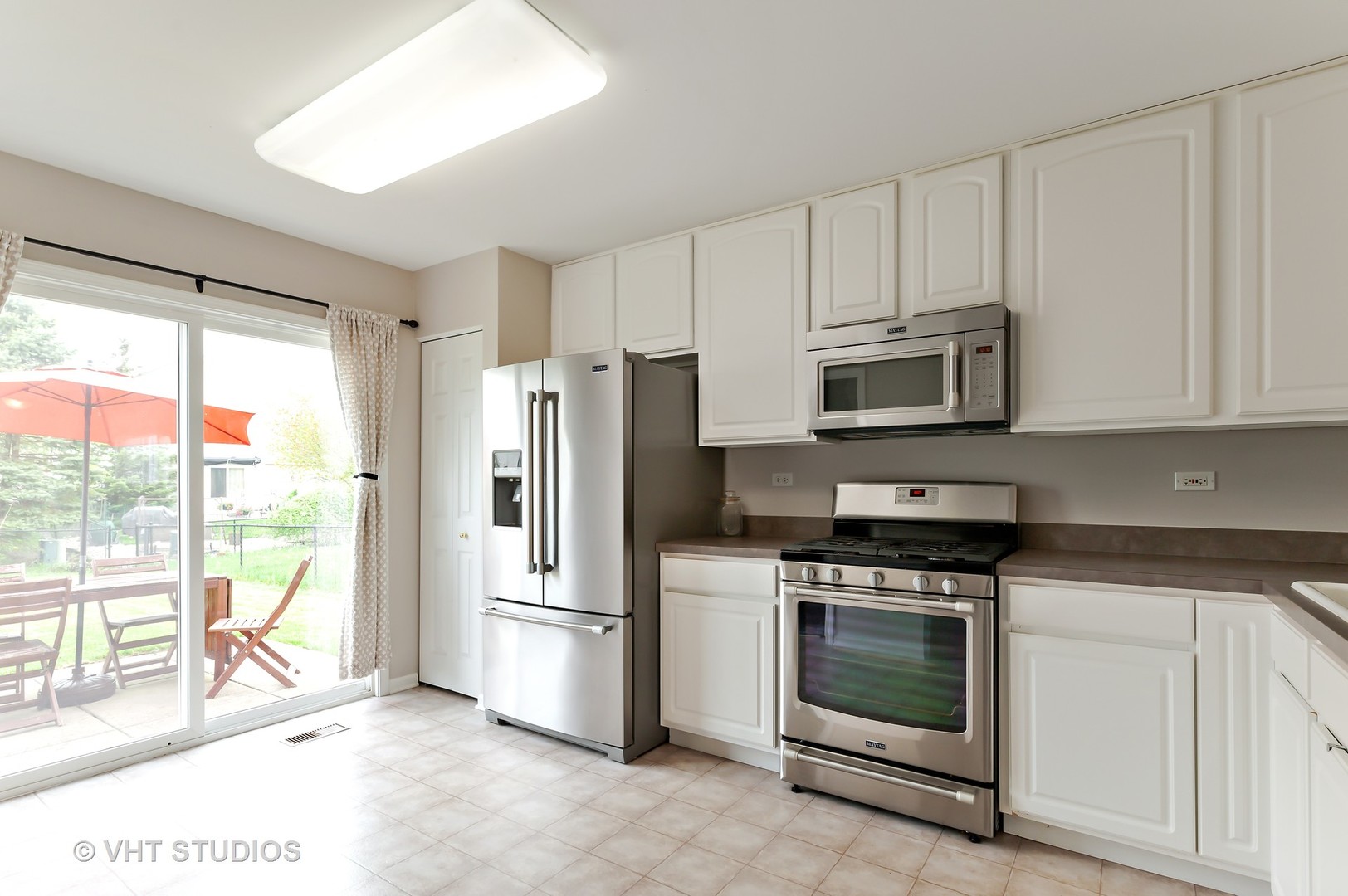 86 Amberly Drive Round Lake, IL 60073 - Photo 6 of 12 a kitchen with stainless steel appliances a stove a refrigerator and a sink