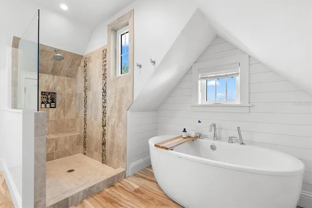 a white bath tub sitting next to a white sink