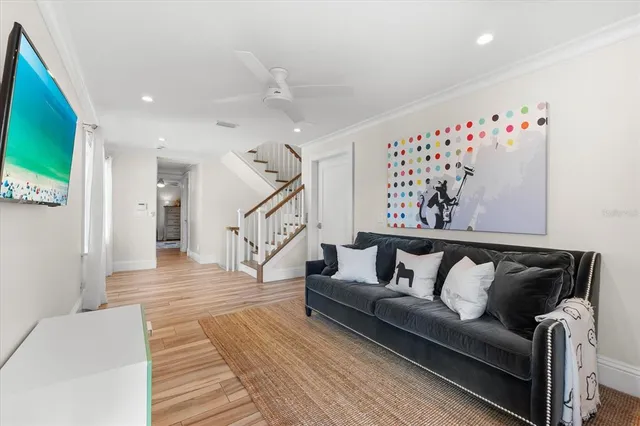 a living room with furniture and stairs