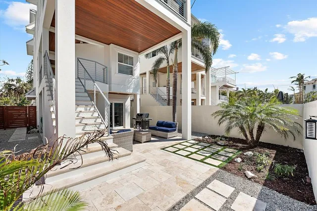 a view of the patio with couches and a potted plant