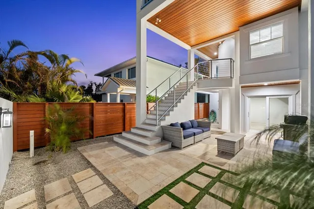 a view of swimming pool with seating area and lake view