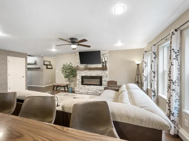 a living room with furniture a fireplace and a flat screen tv