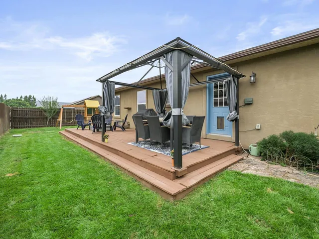 a view of a yard with a patio and a yard