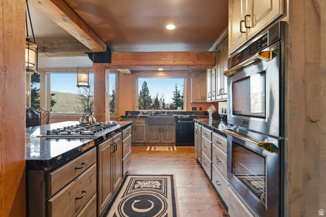 2687 Stewart Road Sundance, UT 84604 - Photo 29 of 48 Kitchen with stainless steel appliances, light wood-style floors, dark stone counters, pendant lighting, and wood finish cabinetry