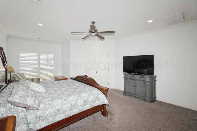 a bedroom with a bed and a television