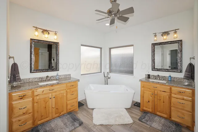 a living room with stainless steel appliances furniture a fireplace and a flat screen tv