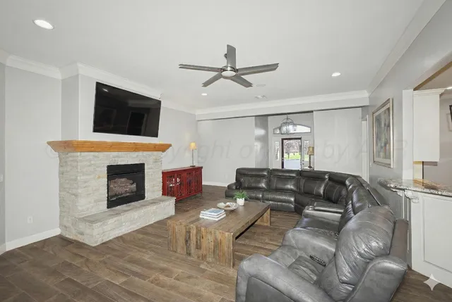 a living room with furniture fireplace and a flat screen tv