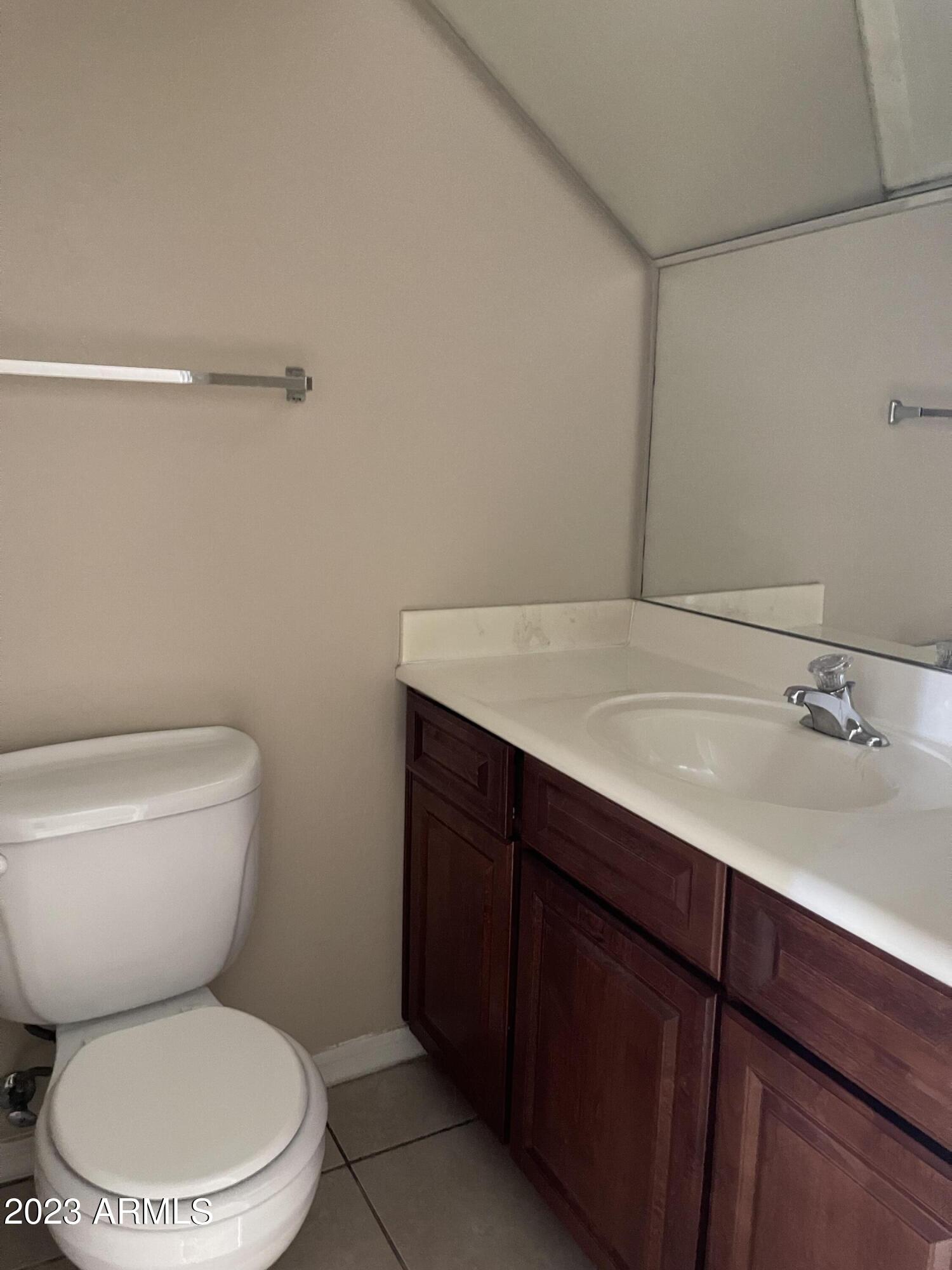 7528 North 19th Avenue, Unit 9 Phoenix, AZ 85021 - Photo 1 of 12 a bathroom with a toilet a sink and mirror