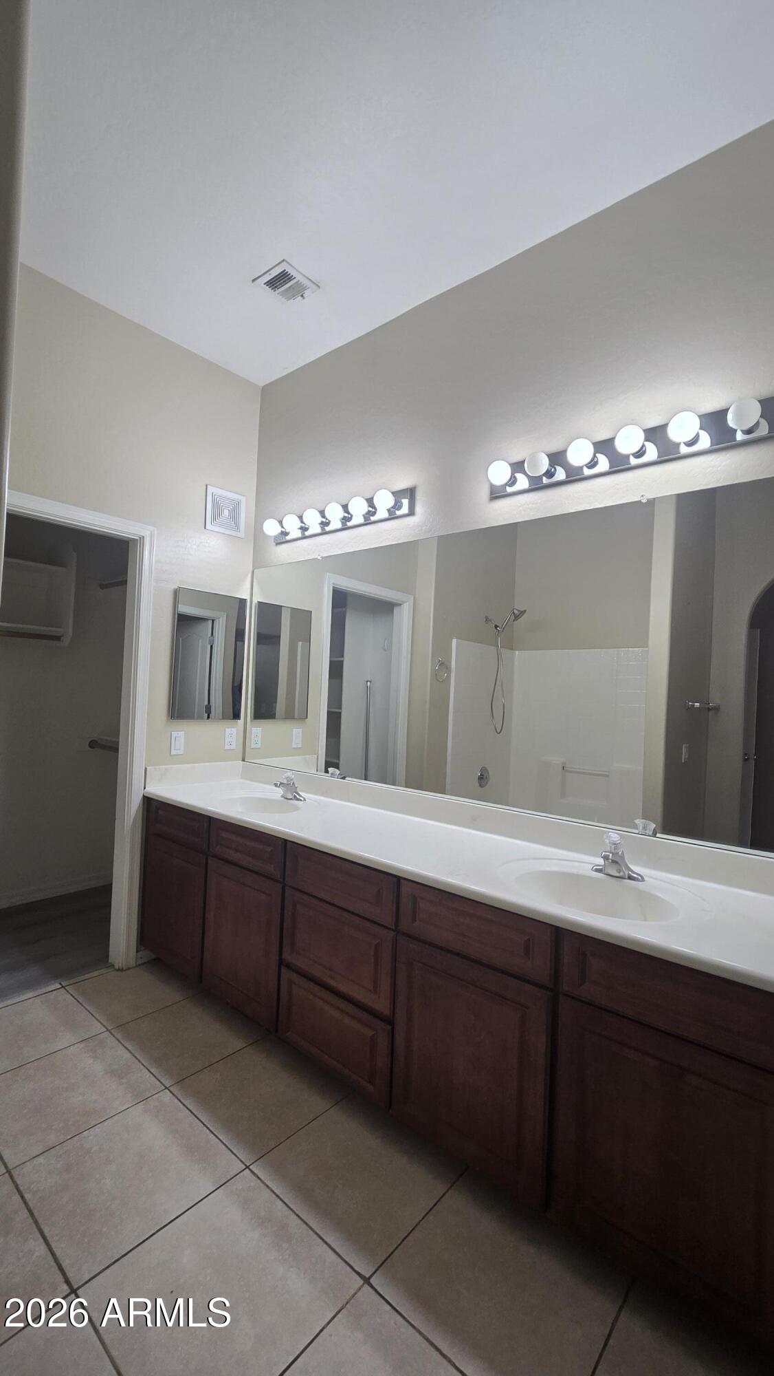 7528 North 19th Avenue, Unit 9 Phoenix, AZ 85021 - Photo 14 of 18 a spacious bathroom with a double vanity sink and a mirror