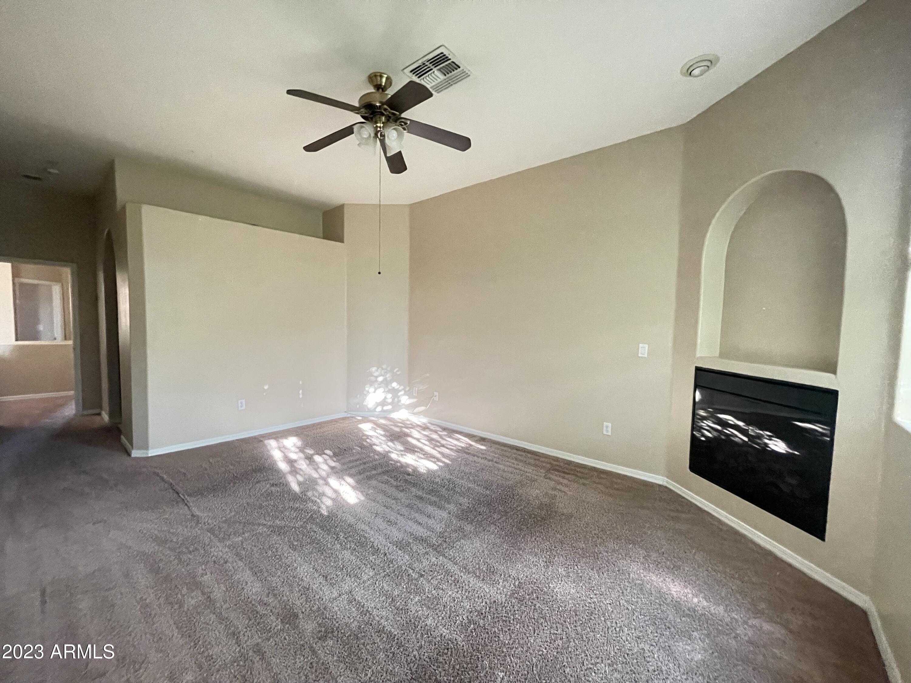 7528 North 19th Avenue, Unit 9 Phoenix, AZ 85021 - Photo 3 of 18 a view of empty room with a fireplace