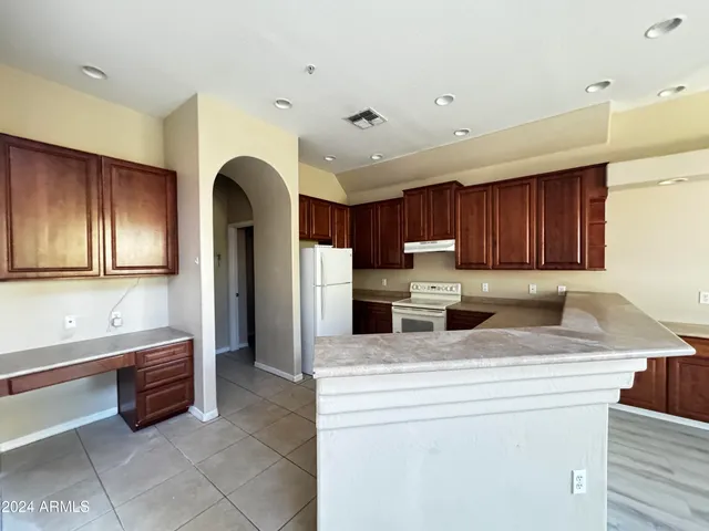 a kitchen with stainless steel appliances granite countertop a sink a stove and a refrigerator