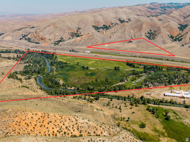 South Echo Frontage Road East Henefer, UT 84033 - Photo 3 of 20 Expansive property featuring a winding river, dense tree coverage, a large building with multiple wings, and surrounding mountainous terrain