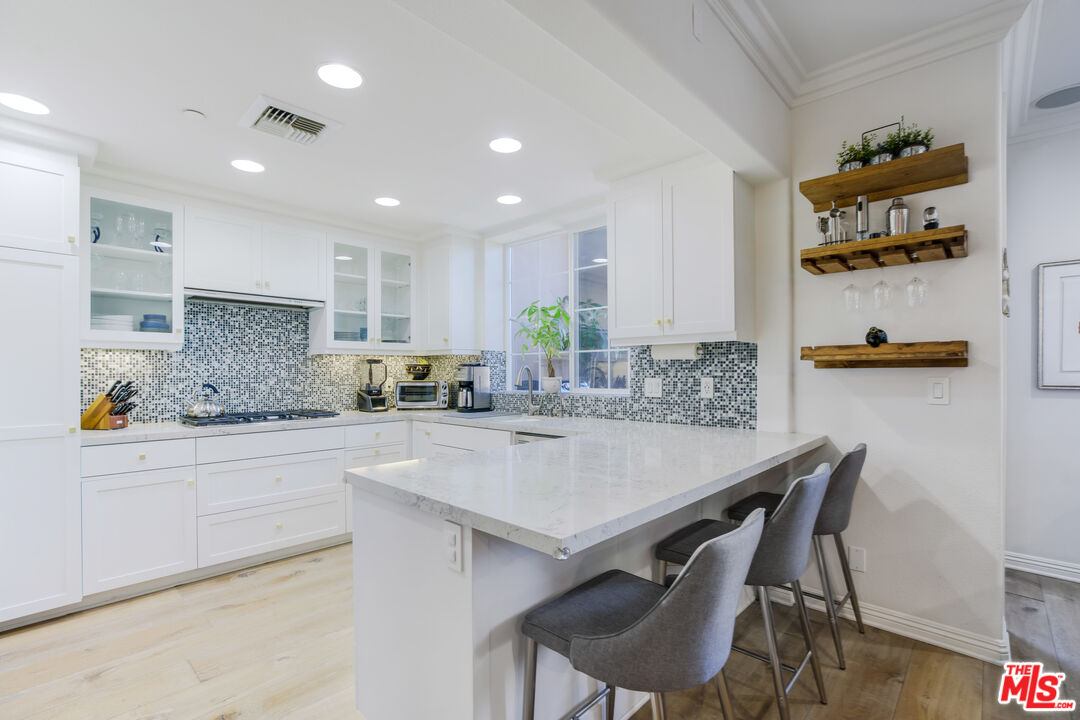 a kitchen with kitchen island cabinets and wooden floor