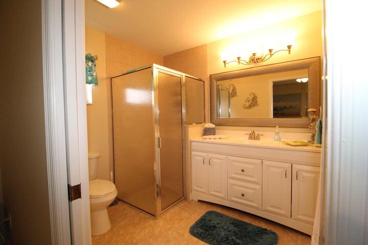 5300 Seagrape Drive Fort Pierce, FL 34982 - Photo 11 of 17 a bathroom with a sink a toilet and shower