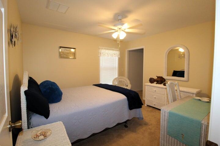 5300 Seagrape Drive Fort Pierce, FL 34982 - Photo 13 of 17 a bedroom with a bed and a chandelier