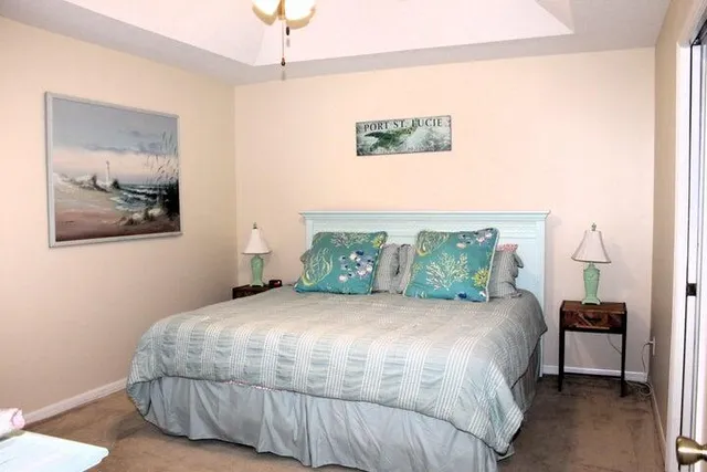 a bedroom with a bed and a painting on the wall