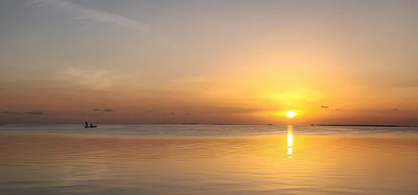 a dining room with furniture and large windows