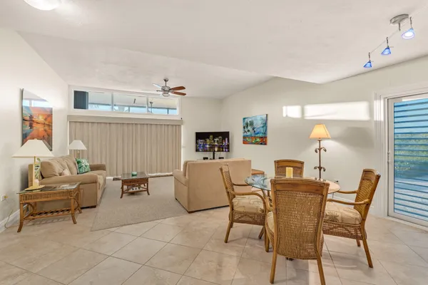 a bathroom with a granite countertop sink a mirror and a toilet