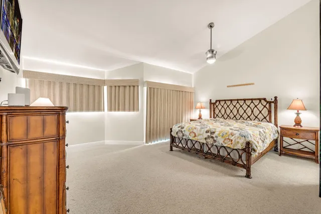 a bedroom with a bed and a mirror