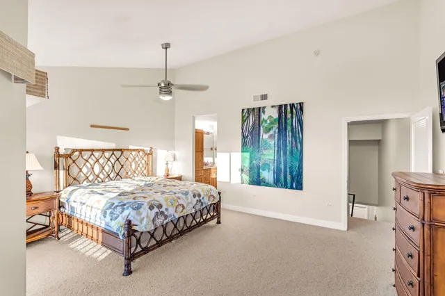 a bathroom with a granite countertop sink a mirror and a toilet