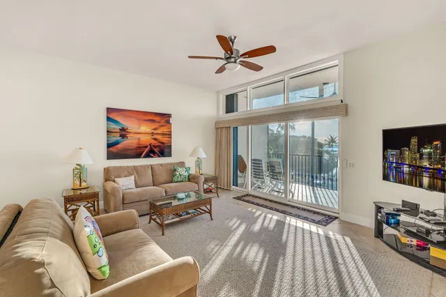 a dining room with furniture and large windows
